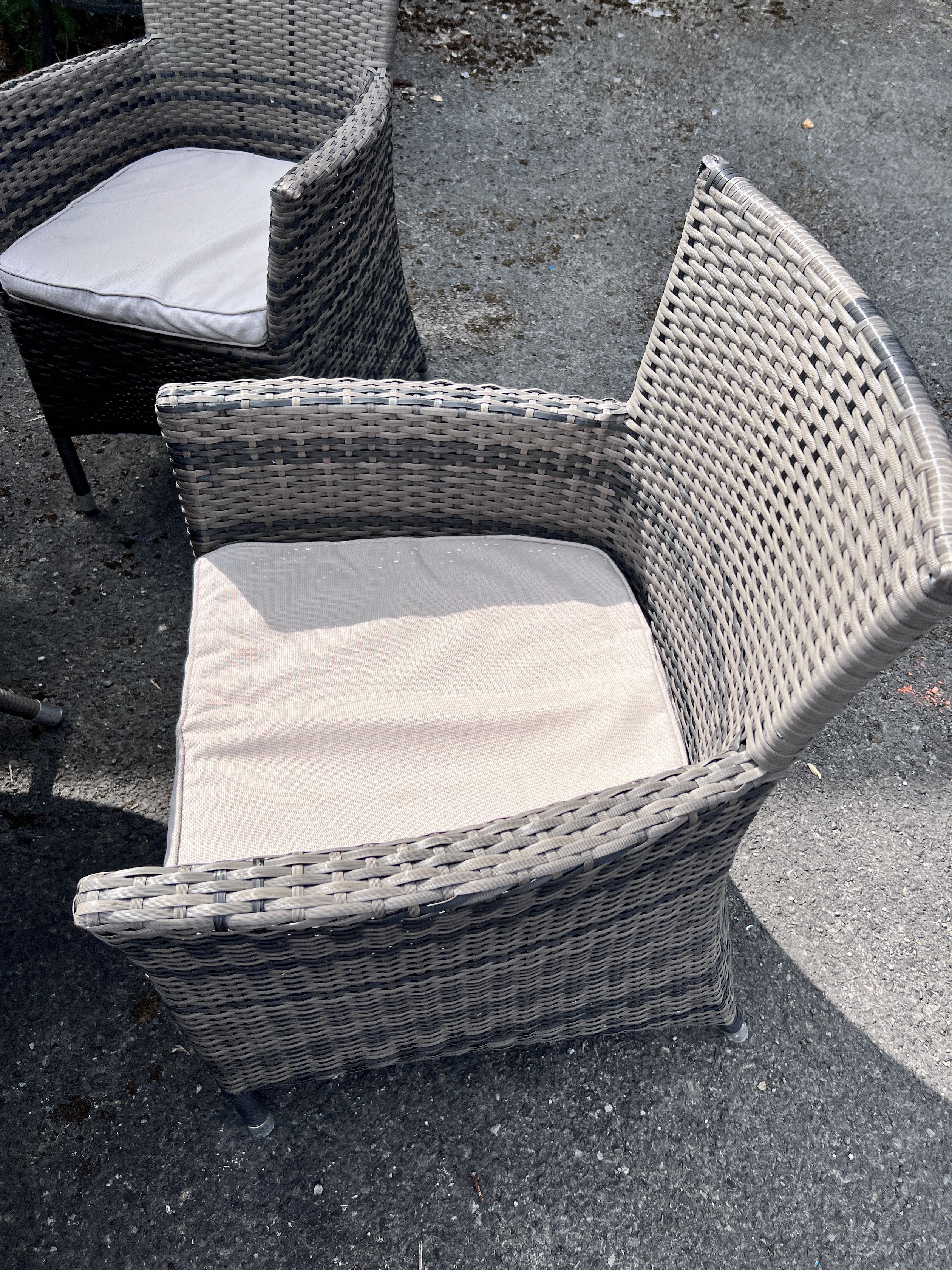 An all weather circular rattan garden table and six chairs with seat cushions, table 136cm diameter, height 75cm